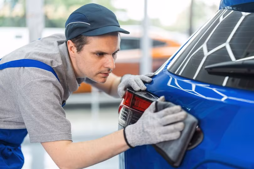 man-using-microfiber-cloth-polishing-car-exterior-royalty-free-image-1684519870.jpg