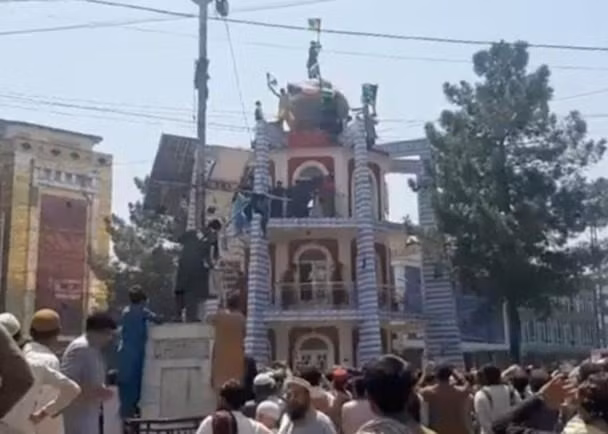 Người biểu tình bỏ cờ Taliban, treo quốc kì Afghanistan ở Jalalabad (Ảnh: Đông Phương).