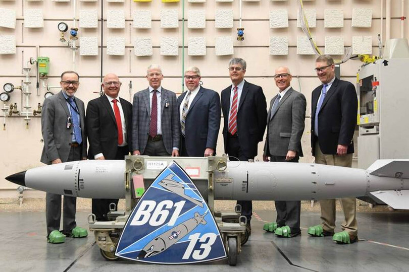 Các quan chức Mỹ chụp ảnh lưu niệm bên quả bom B61-13 đầu tiên được lắp ráp hoàn tất. Ảnh: LTN.