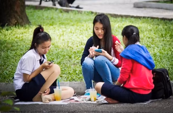 Các thiếu nữ thành phố Hồ Chí Minh sử dụng smartphone (Ảnh: Xinhua).
