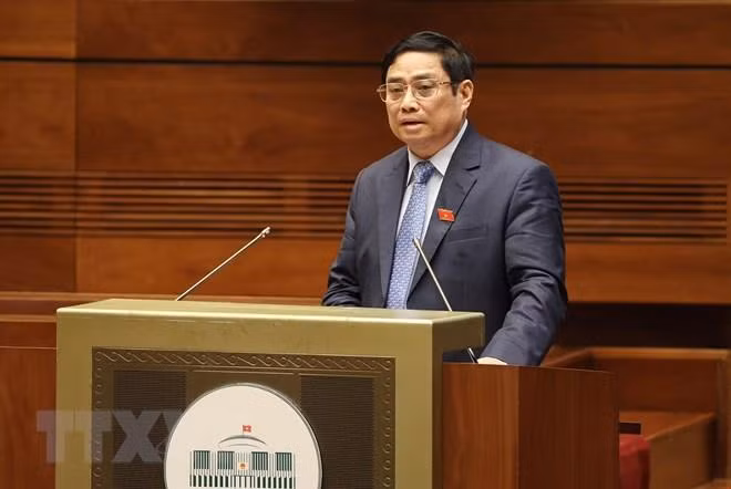 Hình ảnh Thủ tướng Chính phủ Phạm Minh Chính trình bày Báo cáo kết quả thực hiện kế hoạch phát triển kinh tế-xã hội năm 2021; dự kiến kế hoạch phát triển kinh tế-xã hội năm 2022. (Ảnh: Dương Giang/TTXVN)