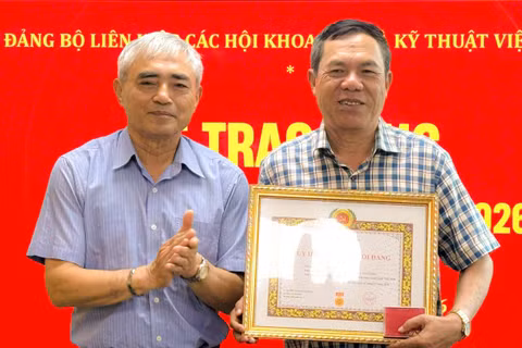 Ông Nguyễn Minh Hồng trao Huy hiệu 40 năm tuổi Đảng cho nhà báo Lê Đức Sảo tại buổi lễ.