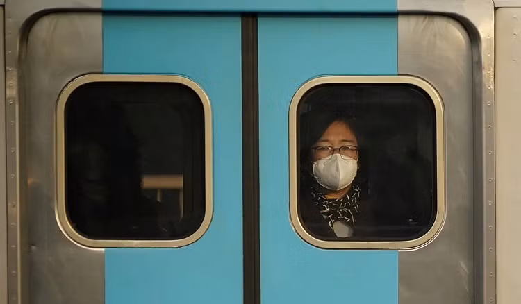 Hành khách đeo khẩu trang trên một chuyến tàu ở Seoul hôm 20/2. Ảnh: Reuters