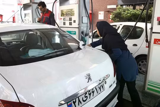 Một người phụ nữ đổ đầy bình xăng xe tại một trạm xăng sau khi giá nhiên liệu tăng ở Tehran, Iran, ngày 15/11/2019. Ảnh: Reuters.