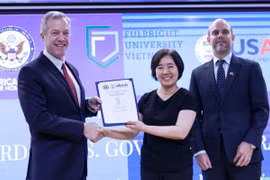 Đại sứ Ted Osius trao quyết định tài trợ từ USAID cho bà Đàm Bích Thuỷ, Chủ tịch ĐH Fulbright Việt Nam. Ảnh:Anh Nguyễn.