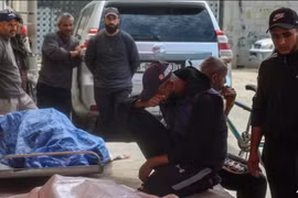 Người thân đau buồn bên thi thể của 3 người đàn ông Palestine thiệt mạng trong cuộc tấn công bằng máy bay không người lái của Israel ở phía đông trại Bureij, tại bệnh viện al-Aqsa Martyrs ở Deir el-Balah, miền trung Dải Gaza vào ngày 17/3. Ảnh: AFP.