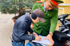 Chủ điểm trông giữ phương tiện vi phạm quy định về việc thu phí ký biên bản. Ảnh: Hiệp Bình.