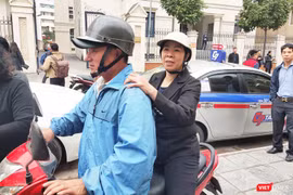 Bị cáo Nguyễn Bích Quy (áo đen đội mũ bảo hiểm ngồi sau) ra về sau khi phiên tòa kết thúc. Ảnh: Minh Thúy. 