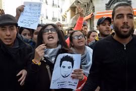 Người biểu tình Tunisia mang theo di ảnh của Yahyaoui tuần hành trên phố. Ảnh: Al Jazeera