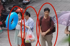Bức ảnh trích xuất từ camera an ninh cho thấy cô bé Zhang Zixin bị 2 người lớn dẫn đi (Ảnh: Getty)