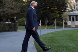 Tổng thống Trump đi bộ đến trực thăng ở Nhà Trắng để vào viện ngày 2/10 (ảnh: Reuters).