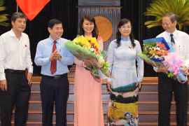 Hai tân Phó chủ tịch UBND TP Nguyễn Thị Thu (giữa) và Lê Văn Khoa (bìa phải) nhận hoa chúc mừng từ Chủ tịch HĐND TP Nguyễn Thị Quyết Tâm (thứ hai từ phải qua) và Chủ tịch UBND TP Nguyễn Thành Phong (thứ hai từ trái qua) - Ảnh: Hoàng Triều
