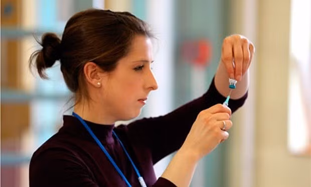 Một y tá chuẩn bị tiêm ngừa vắc xin cho trẻ tại Anh. Ảnh: Athena