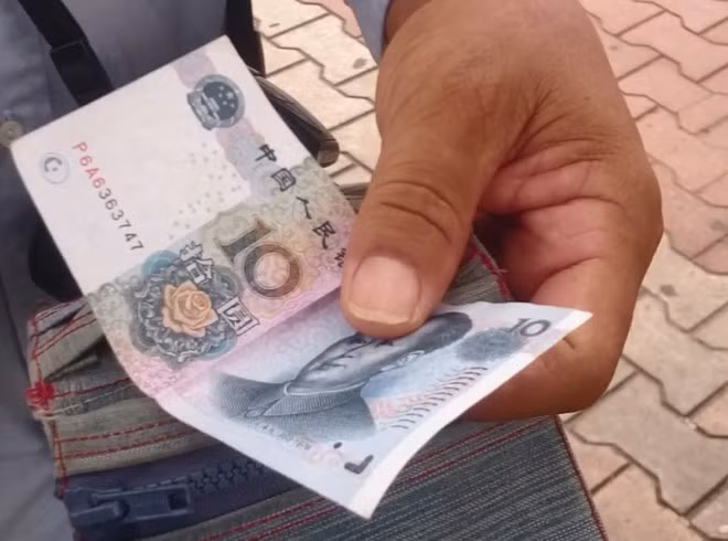 Nhiều du khách Trung Quốc vẫn dùng tiền Nhân dân tệ ra thanh toán khi mua hàng. Ảnh:H. Long. Nhiều du khách Trung Quốc vẫn dùng tiền Nhân dân tệ ra thanh toán khi mua hàng. Ảnh:H. Long.