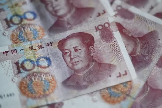 Đồng tiền giấy mệnh giá 100 NDT (15.5 USD) tại Bắc Kinh ngày 25/8 vừa qua. (Ảnh: AFP/TTXVN)