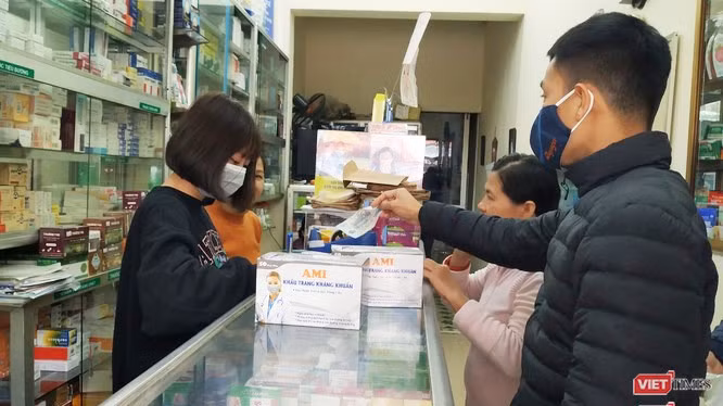 Người dân mua khẩu trang tại hiệu thuốc. Ảnh: Lê Mai 
