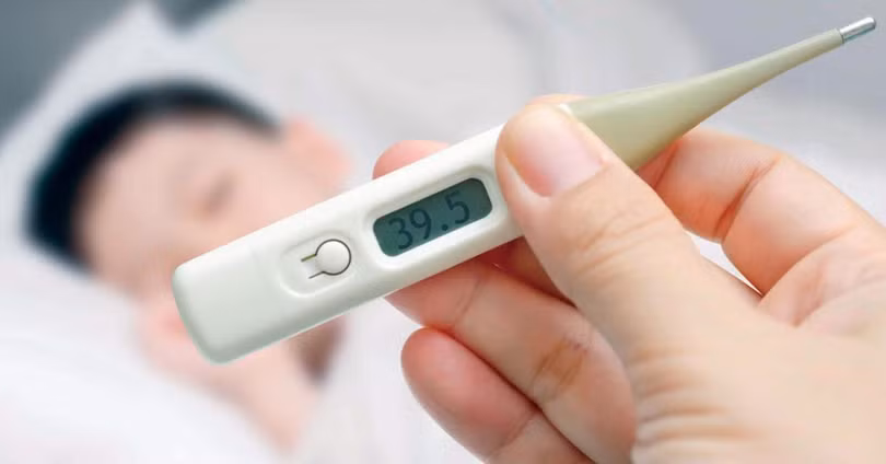 Cha mẹ kiểm tra nhiệt độ cho con (Ảnh minh hoạ)