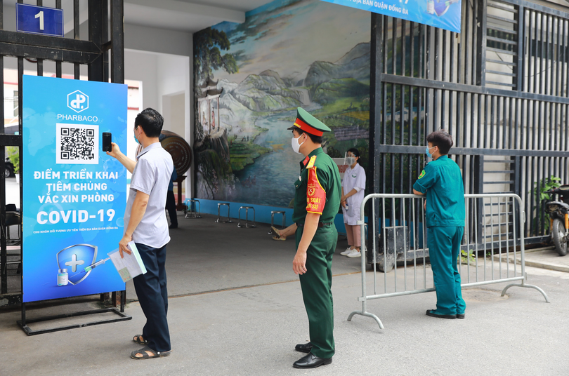 Người dân đến tiêm được hướng dẫn khai báo y tế qua hệ thống quét mã QR, tránh tiếp xúc không cần thiết (Ảnh - Pharbaco)