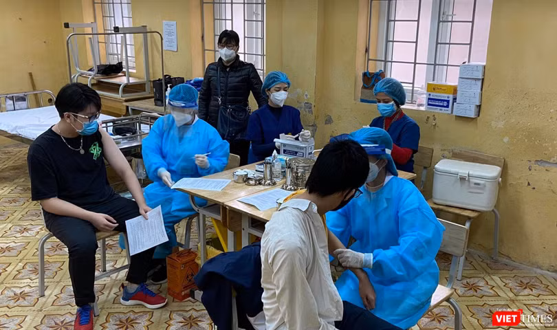 Học sinh được khám sức khoẻ trước khi tiêm vaccine COVID-19 (Ảnh - Quang Hùng) 