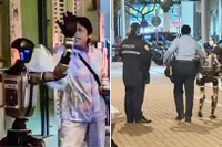 Một người máy hình người được cảnh sát hộ tống trên đường phố Macau, Trung Quốc. Ảnh: IE.