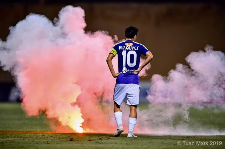 Cổ động viên Nam Định bắn pháo sáng vào sân. Ảnh CĐVHN.