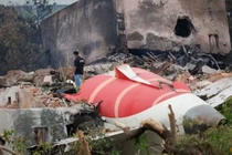 Một nhân viên cứu hỏa đứng cạnh chiếc máy bay Boeing 787-8 Dreamliner của Air India bị rơi tại Ahmedabad, Ấn Độ vào ngày 13/6. Ảnh: Reuters.