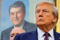 Tổng thống Donald Trump, trước bức tranh của cố Tổng thống Ronald Reagan, tại Phòng Bầu dục ở Nhà Trắng ở Washington, D.C. Ảnh: Reuters.