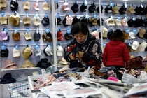 Khách hàng mua găng tay tại cửa hàng Wankelai ở Bắc Kinh, Trung Quốc ngày 27/2. Ảnh: Reuters.