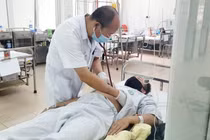 PGS.TS. Đỗ Duy Cường thăm khám cho bệnh nhân tại Trung tâm bệnh nhiệt đới, Bệnh viện Bạch Mai (Ảnh - BVCC) 