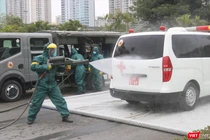 Nhân viên y tế phun khử khuẩn xe cấp cứu (Ảnh - Minh Thuý) 