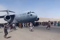 Cảnh người dân bám và chạy theo khi chiếc C-17 cất cánh (Ảnh: Đông Phương).