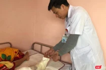 Bác sĩ Nguyễn Vũ Hoàng - Khoa Chỉnh hình Nhi, thăm khám chân cho cháu bé (Ảnh: BVCC) 