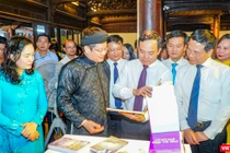 Phó Thủ tướng Chính phủ Trần Lưu Quang (người cầm sách) và Bộ trưởng Bộ TT&TT Nguyễn Mạnh Hùng (bên trái Phó Thủ tướng) tham quan triển lãm sách tại lễ khai mạc Ngày Sách và Văn hóa đọc Việt Nam lần thứ hai.