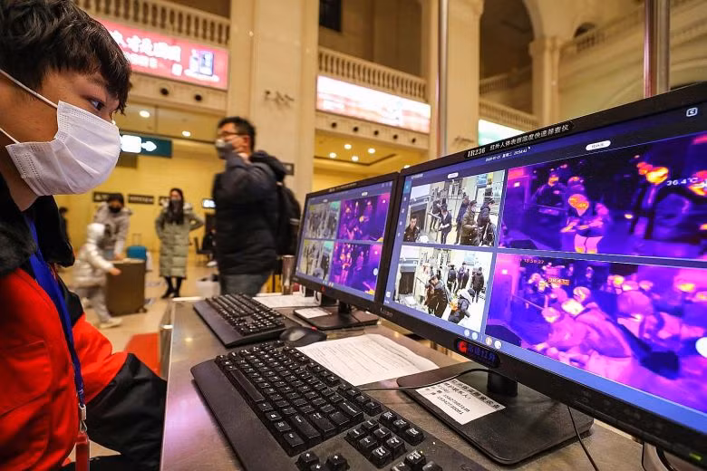 Nhân viên theo dõi máy đo thân nhiệt để phát hiện người nghi mắc bệnh. Ảnh: EPA-EFE