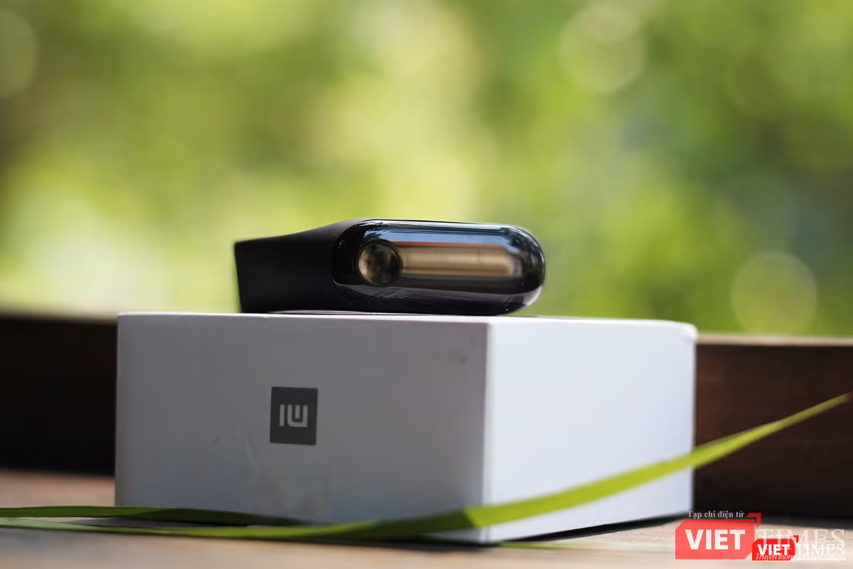 Còn đây là chiếc Mi Band 3. Chúng ta có thể thấy nó có mặt kính với nút cảm ứng khá to, hơi lồi so với Mi Band 2. Vỏ nhựa hình viên thuốc, có thể dễ dàng lắp vào dây đeo cao su