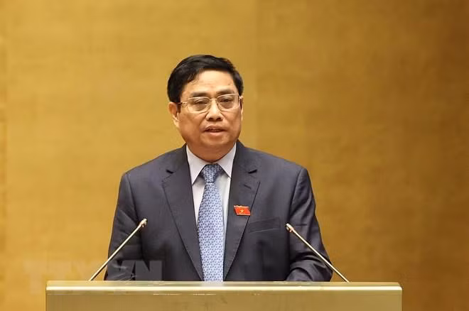 Thủ tướng Chính phủ Phạm Minh Chính trình bày Báo cáo kết quả thực hiện kế hoạch phát triển kinh tế-xã hội năm 2021; dự kiến kế hoạch phát triển kinh tế-xã hội năm 2022. (Ảnh: Dương Giang/TTXVN)